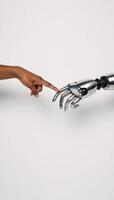 Robot hand touching AfricanAmerican arm on pure white backdrop symbolic representation of tech humanity connection photo