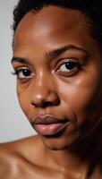 Closeup portrait emphasizing expressive features and vibrant skin tone of young African American person with natural hair photo
