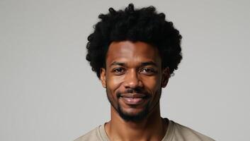 African American Man with Afro Hair stands alone against an empty backdrop photo