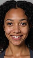 Closeup photo of a young Black woman with curls and a gentle smile