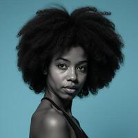 African American woman with an Afro against a blue backdrop photo