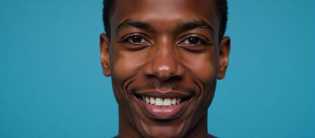 Closeup portrait of an elated African American male model with brown hair against a blurred deep sky blue background with ample copy space photo