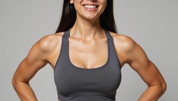 Female athlete wearing sports bra with smiling expression photo
