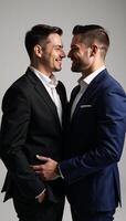 Exquisite studio portrait of gay couple using cinematic lighting against simple background photo
