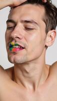 A man sporting vibrant colorful lips depicted in a closeup shot representing either Pride or LGBTQ themes photo