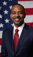 AfricanAmerican businessman in suit and tie before an American flag photo