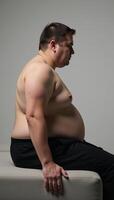 Conceptual artwork depicting an overweight person sitting on a couch Obesity photo