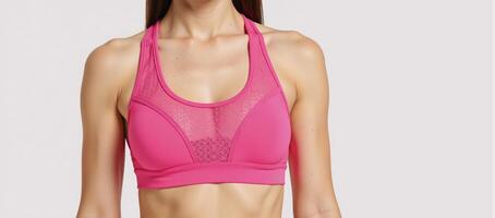 A breathable pink sports bra featuring a stylish mesh design for comfort during workouts photo