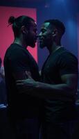 A black gay couple is depicted during a romantic intimate moment in a dimly lit atmospheric nightclub photo