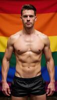 Logo features a muscular gay man in leather shorts against an LGBTQ flag backdrop photo