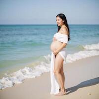 Pregnant woman on the beach embracing motherhood while gazing at the sea photo