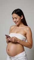 Portrait pregnant woman smiling with smartphone against background photo
