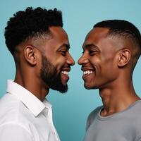Portrait of two 19year old African American men smiling as their first love unfolds against a soft pastel blue backdrop photo
