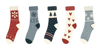 Collection of colorful winter socks with various festive patterns, isolated on a white background. Knitted wool and cotton socks featuring snowflakes, hearts, trees, and geometric designs. Flat vector