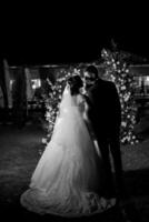 girl and guy against the background of a night wedding arch photo