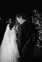 girl and guy against the background of a night wedding arch photo