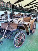 an old fashioned carriage is in a warehouse photo