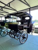 an old fashioned carriage is parked in a building photo