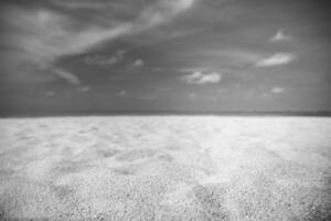 A black and white photo of the sand on the beach