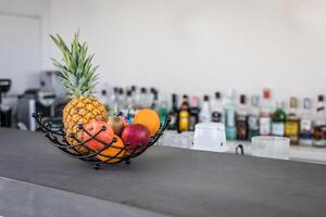 A black counter with fruit in a bowl photo