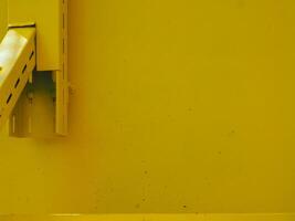 Yellow painted steel texture for a close-up background of a building or construction. photo