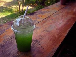 Kiwi soda drink in the garden cafe photo