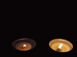 Scented candles in the dark at night for a spa or relaxation background. photo