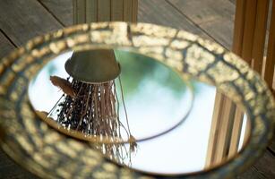 Round mirror in a golden frame. With the reflection of the sky. Beauty is in the details photo