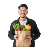 Smiling young man holding groceries vegetable shopping bag standing isolate on transparency background png