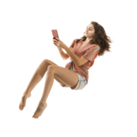 full body young woman laying in the air floating while using smart phone isolate on transparency background png