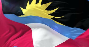 Antigua and Barbuda flag waving at wind in slow with blue sky, loop video