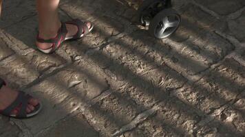 View of the feet of walking tourists. People in boots walking on roads on asphalt. video