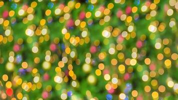 Christmas lights in bokeh outside in december Snow and bokeh in blue yellow and other colors on green Christmas pine background modern technology. photo