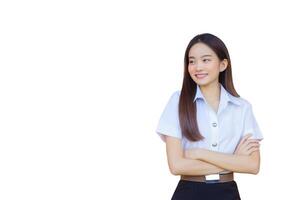 Portrait of an adult Thai student in university student uniform. Asian beautiful girl standing smiling happily and confidently with her arms crossed while isolated white background. photo