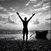 A man is standing on the beach with his arms raised photo