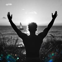 A man is standing on a beach and is holding his hands up in the air photo