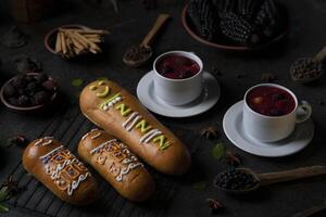 Guaguas de Pan with cups of Colada Morada, traditional Ecuadorian food for the day of the dead, surrounded by the ingredients to cook the colada photo