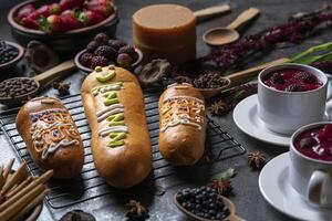 Guaguas de Pan with cups of Colada Morada, traditional Ecuadorian food for the day of the dead, surrounded by the ingredients to cook the colada photo