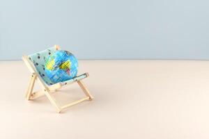 Chaise lounge with dollars and globe on a light background. photo