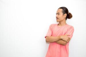 Asian, Indonesian man standing wearing pink shirt pointing right, left, up, down and presenting using hand gestures. Isolated on white background photo
