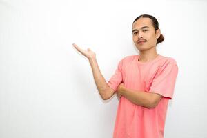 Asian, Indonesian man standing wearing pink shirt pointing right, left, up, down and presenting using hand gestures. Isolated on white background photo