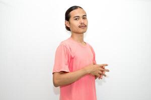 An Indonesian, Asian man wearing a pink tshirt formal style involving his partner with standing confidence like a mature person and a young businessman. isolated in white background photo