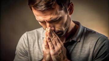 Thoughtful man with hands clasped in contemplation photo