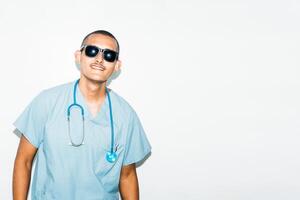 man dressed as doctor with summer sunglasses, smiling and cheerful. summer concept. photo
