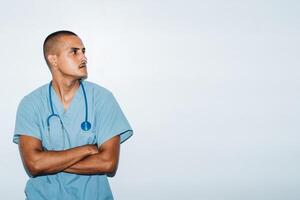 Latin American doctor with folded arms looking in concentration. on a white background. photo