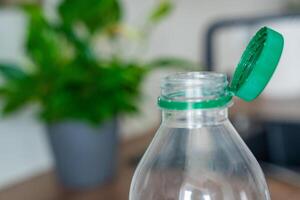 Stationary plastic cap on a PET bottle. The new design means the cap remains attached to the bottle after opening, making the entire package easier to collect and recycle. High quality photo