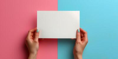 Hand holding a blank white box on colorful paper background during creative workspace setup photo