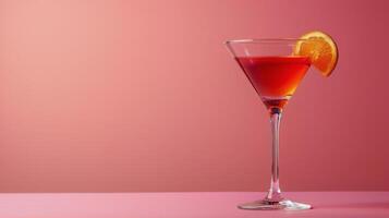 Elegant cocktail garnished with a slice of citrus on a festive pink background photo