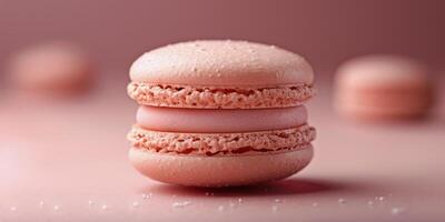 Delicate pink macaron resting on a pastel surface with scattered crumbs and decorations photo