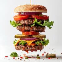a hamburger with lettuce, tomato, onion and pickles photo